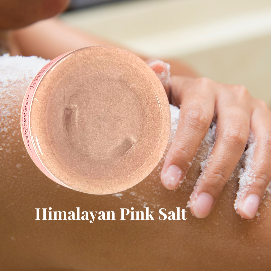 A woman rubbing salt on her shoulder with  Himalayan Pink Salt Butter Top Body Scrub in front of her